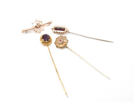 A group of antique Victorian jewellery. The lot to include three stick pins; one with a 9ct gold finial set with a red stone 