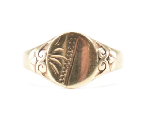 A hallmarked vintage 9ct yellow gold signet ring. The ring having a round head with etched design on a tapered shank with scr