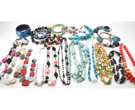 A collection of vintage costume jewellery to include beaded necklaces, pop corn bracelet and bangle, faux jade bangles and gl