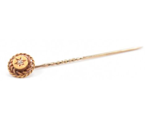A 19th Century Victorian 15ct gold and and diamond stick pin. The pin having a round finial to the top with rope twist detail