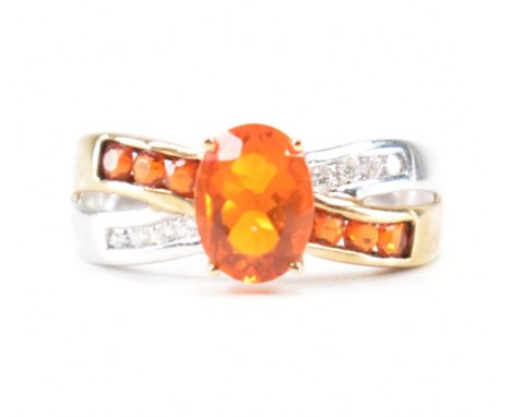 A hallmarked 9ct gold fire opal. The ring being set with an oval cut fire opal to the centre within a crossover setting flank