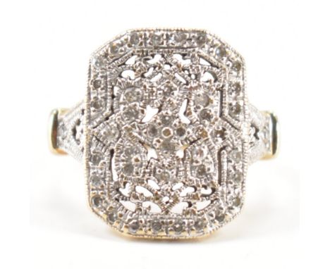 A vintage gold and diamond panel ring. The ring having a canted rectangular panel to the head set throughout with diamond acc