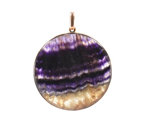 A vintage gold and blue john mounted pendant. The pendant being set with a round blue john panel in a bezel set gold mount wi