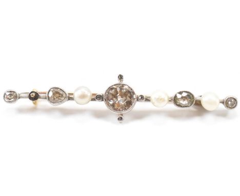 A 1920s gold platinum diamond and pearl brooch pin. The brooch set with a central old cut diamond having rose cut diamond acc