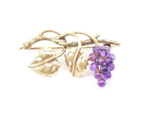 A hallmarked 9ct gold and amethyst brooch. The brooch in the form of a grape vine with amethyst beads as grapes. Hallmarked B