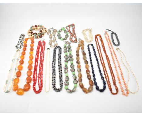 A collection of beaded necklaces. The lot to include simulated amber, glass, mother of pearl, hematite, cultured pearl, coral