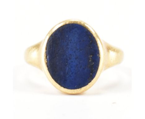 A hallmarked 18ct gold signet ring having oval lapis lazuli panel to centre set within a bezel mount. Makers marks for Willia