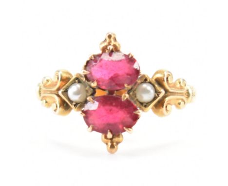 A 19th Century Victorian gold paste and seed pearl ring. The ring being set with two red paste stones flanked by two half pea