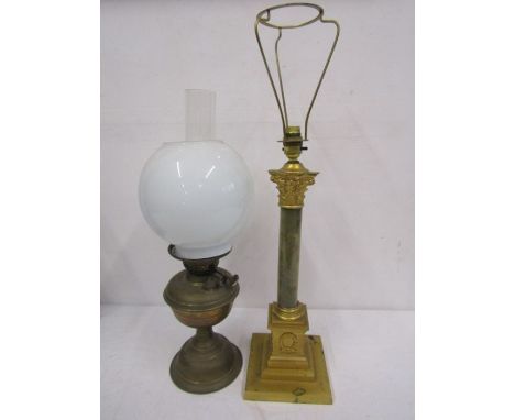 An oil lamp and brass lamp base