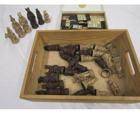 A carved chess set and dominoes