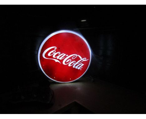 An LED light up Coca-Cola sign with wall fixings