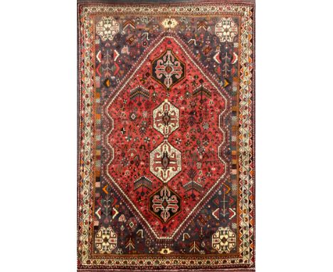 A South west Persian Qashgai carpet, hand-knotted in earthy tones of red, brown and ochre, 250cm x 160cm.