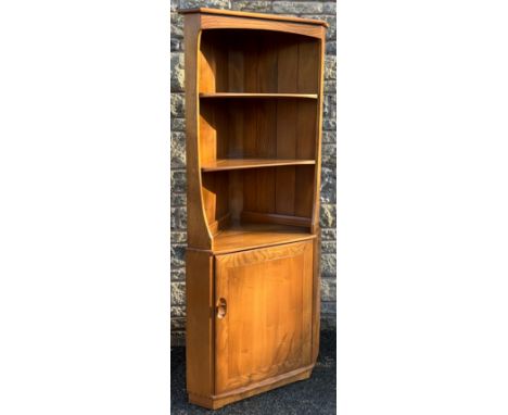 An Ercol Windsor elm floor standing corner cabinet, 179cm high x 53cm wide.