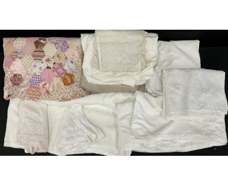 A Victorian patch work quilt, of hexagonal patterned panels in tones of pink, purple, cream, floral, striped, black, multi co