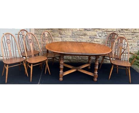 An Ercol Woburn model extending dining table, in elm, 72cm high x 163cm long (213cm extended) x 108cm wide;  along with a set