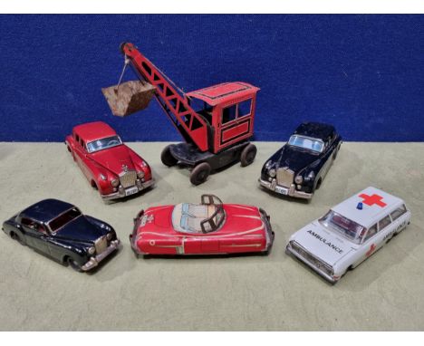 Two tinplate battery operated Rolls-Royce Saloons, a Japanese tinplate Car, another Car, an Ambulance and a Crane