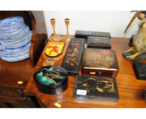 A collection of&nbsp;lacquered and other trinket boxes, a wall plaque and a pair of candle sticks