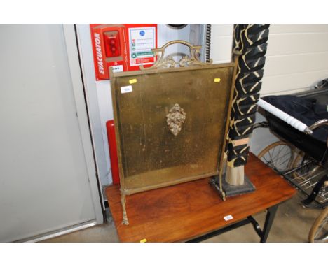 A brass fire screen 