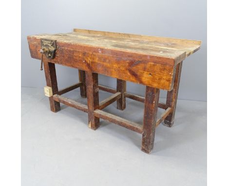 A vintage stained pine work bench, with Record vice. 135x77x69cm 