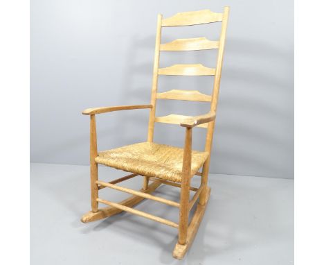 Neville Neal, an LCC Arts &amp; Crafts Cotswold school Ernest Gimson design ladder back rocking chair in ash with rush seat, 