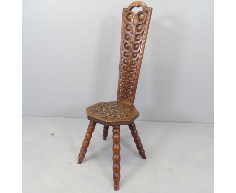 A carved oak spinning stool, on bobbin turned legs. 
