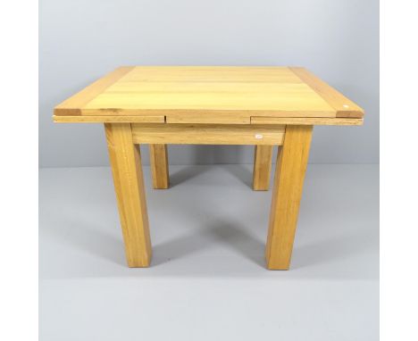 A modern light oak draw-leaf dining table. 110 (extending to 190) x79x90cm. 