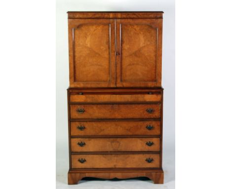 CAMEO FURNITURE, GEORGIAN STYLE BURR WALNUTWOOD TALLBOY, the moulded oblong top above a pair of cupboard doors, enclosing two