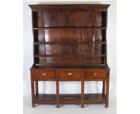 EIGHTEENTH CENTURY OAK DRESSER, the plate rack with moulded cornice above three shelves and plank back, the advanced lower se