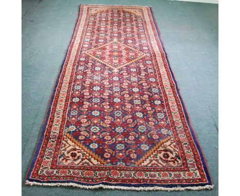 SHIRAZ PERSIAN RUNNER.  With diamond shaped crimson medallion on a midnight blue field with a close formal floral and foliate