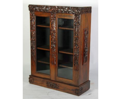 A VICTORIAN ROSEWOOD DWARF BOOKCASE ENCLOSED BY TWO GLASS PANEL DOORS, originally with a marble top (now absent), decorated w