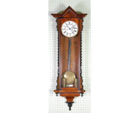 LATE VICTORIAN FIGURED WALNUT CASED VIENNA WALL CLOCK, the 6 1/2" two part enamelled Roman dial (cracked), powered by a thin 