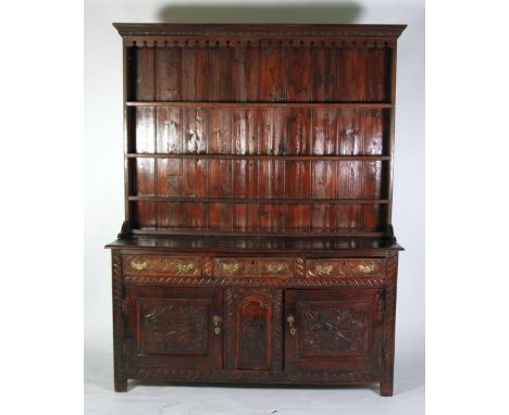 ANTIQUE CARVED OAK DRESSER WITH ASSOCIATED COMPOSITE PLATE RACK, the moulded oblong top above three frieze drawers, fitted wi