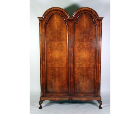 MAPLE AND CO., QUEEN ANNE STYLE DOUBLE DOME TOP FLAME CUT MAHOGANY AND CROSSBANDED WARDROBE, the moulded cornice above a pair