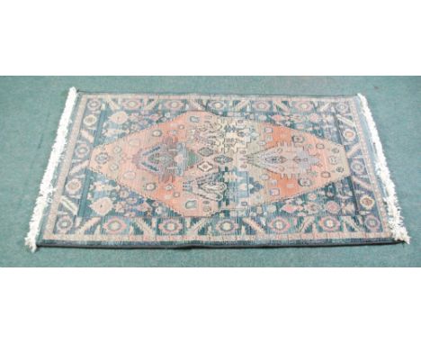 EGYPTIAN 'GABBEH' MACHINE WOVEN RUG. The central lozenge shaped panel having a four medallion pattern on a faded  pink ground