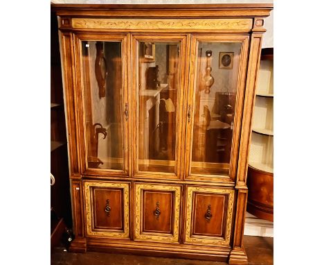 An early 20th century oak glazed display cabinet, lighter oak inlay, three glazed doors, flanked by moulded inlay columns, fi