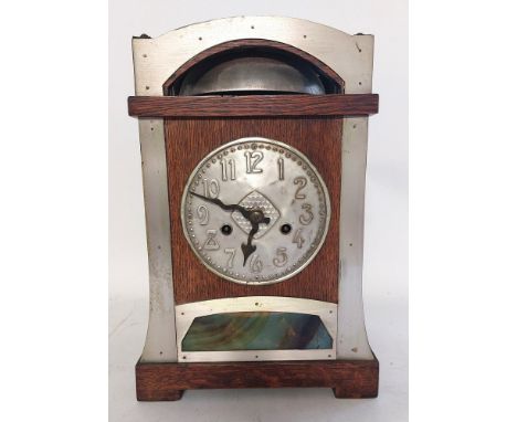 A German oak cased secessionist 14 day strike mantel clock, made in Wurttemburg. with a raised bell cover and embossed dial w