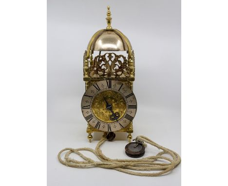 A 20th Century brass lantern clock of typical form, 16cm silvered chapter ring with Roman numerals, height 39cm, (lead weight