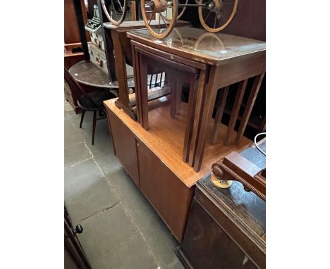 Four items of mid century furniture; a teak cabinet, a nest of tables, a bookcase/side cabinet and a small drop leaf table. 