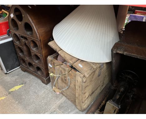 A vintage wooden box containing a witch's house, a Tesla style lamp, a wooden bottle holder and a Art Deco style lamp with sh