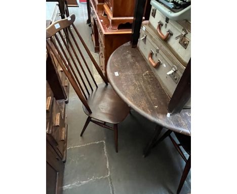 An Ercol drop leaf dining table and four Ercol 'Goldsmith' chairs. 