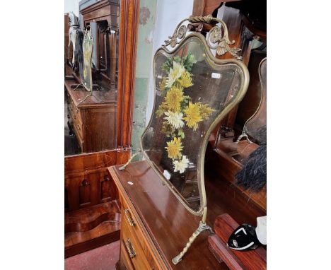 An Edwardian brass and mirrored glass fire screen, hand painted with flowers. 