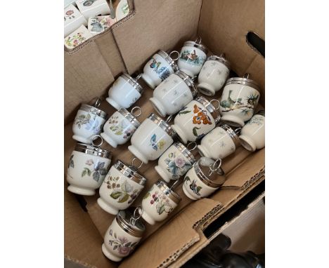 A box containing 18 medium and small egg coddlers by royal Worcester. Patterns include birds, flowers and fruit. 