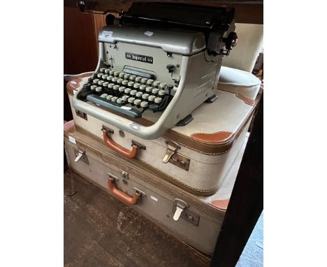 Two vintage cases and an Imperial 66 typewriter. 