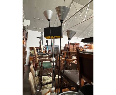 A chrome and ceramic standard lamp and a three branch floor lamp. 