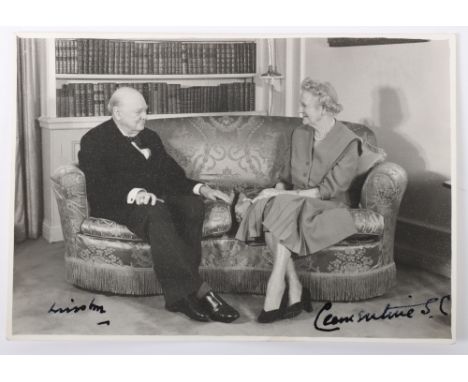 Signed Photograph of Winston Churchill and his wife Clemantine showing them sitting on a sofa at Chartwell in relaxed mood. S