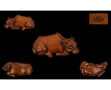 A Japanese Carved Boxwood Netsuke, In The Form of a Water Buffalo, Excellent Condition In All Aspects, Signed to Base. Height