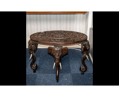 Antique Oval Shaped Carved Teak Indian Colonial Table, The Top Profusely Carved with Flowers and a Central Panel Depicting Bu