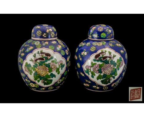 Pair of Chinese Porcelain Famille Rose Ginger Jars with Covers, the central panels decorated with birds amongst roses, the bo