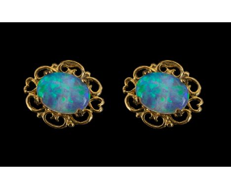 A Pair of 9ct Gold Opal Stud Earrings, Post and butterfly fastening. 10 by 8 mm. 