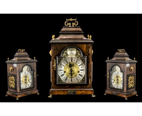 Walnut Bracket Clock with brass arch dial and canopy top.  Three hole aperture, Westminster chime, acorn finials, with decora